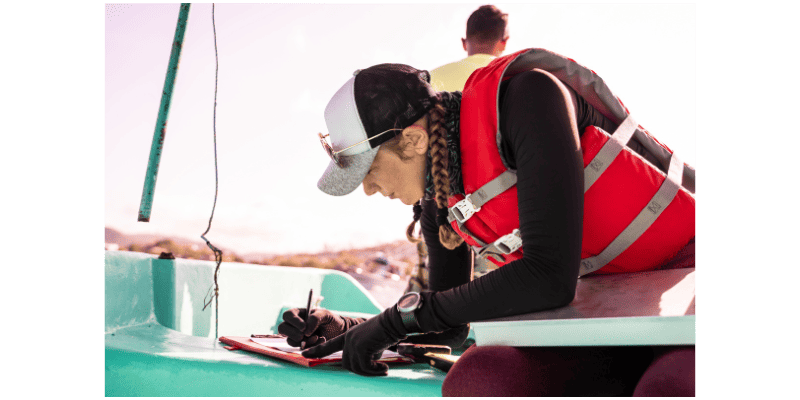a woman writing on a clipboard