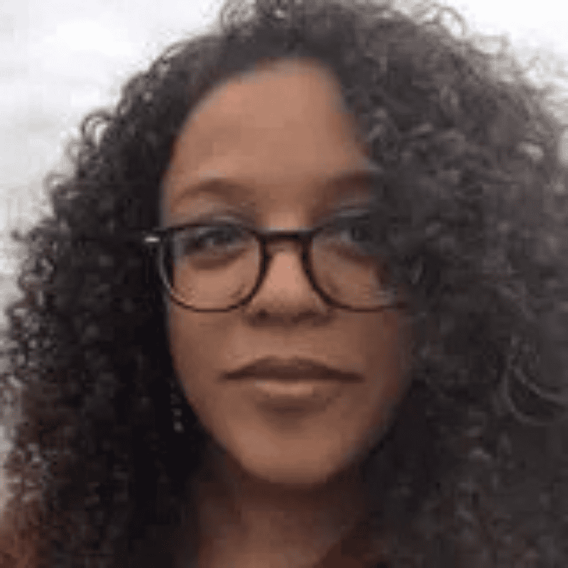 a woman with curly hair wearing glasses
