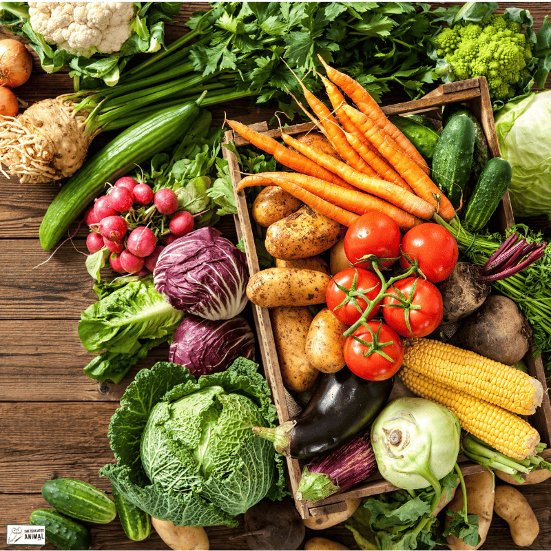 a group of vegetables in a wooden box